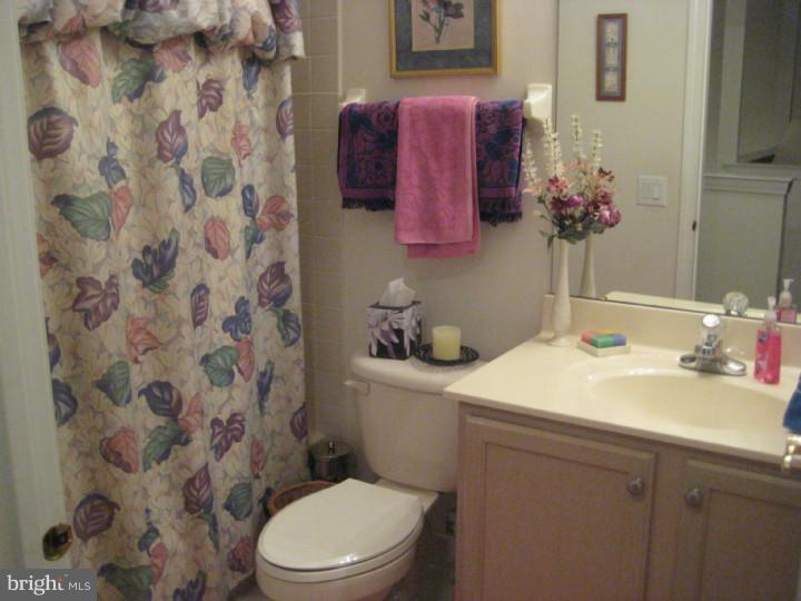 23 Brecht Road Hamilton, NJ 08690 - Photo 12 of 15 a bathroom with a sink a toilet and shower curtain