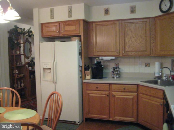 23 Brecht Road Hamilton, NJ 08690 - Photo 3 of 15 a kitchen with stainless steel appliances granite countertop a refrigerator a sink and white cabinets