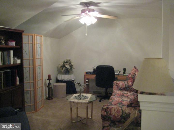 23 Brecht Road Hamilton, NJ 08690 - Photo 8 of 15 a living room with furniture a bookshelf and a chandelier