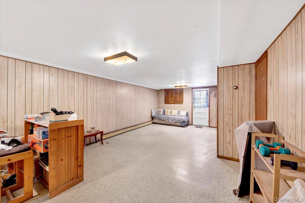 733 Rhinelander Avenue Bronx, NY 10462 - Photo 23 of 31 Bedroom featuring wooden walls and baseboard heating