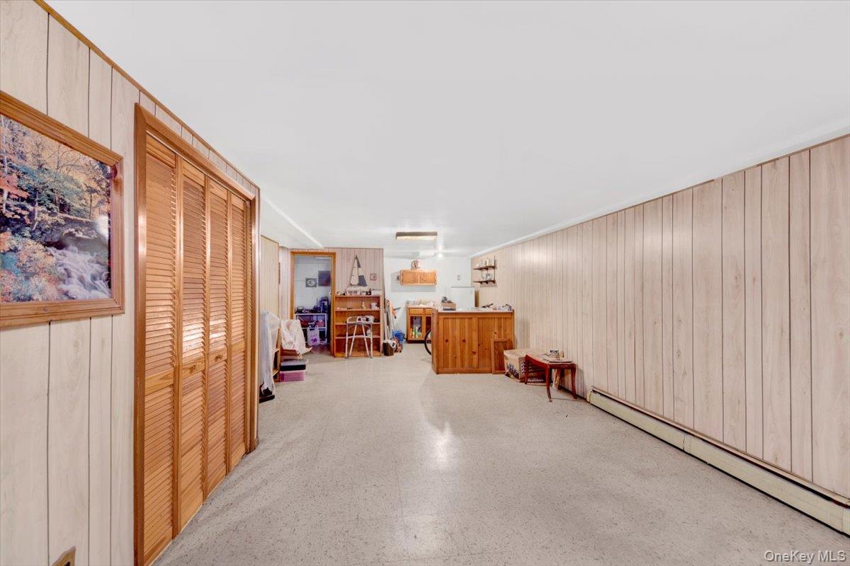 733 Rhinelander Avenue Bronx, NY 10462 - Photo 24 of 31 Corridor featuring wooden walls and a baseboard heating unit