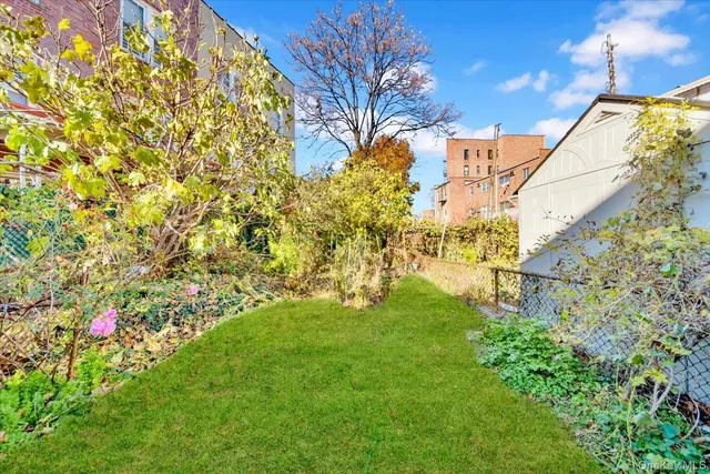 a view of yard with fountain and wooden fence