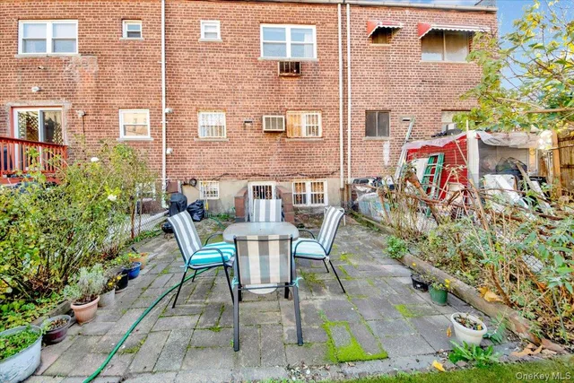 a view of a patio with a table and chairs and potted plants