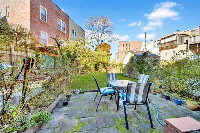 a view of a patio with table and chairs and potted plants