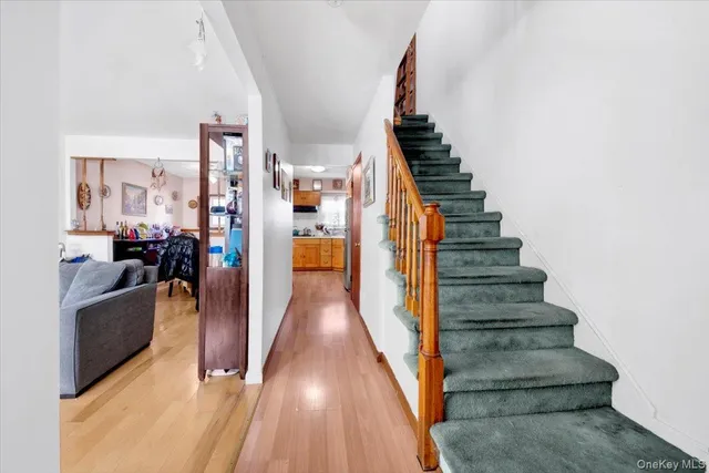 a view of entryway and hall with wooden floor