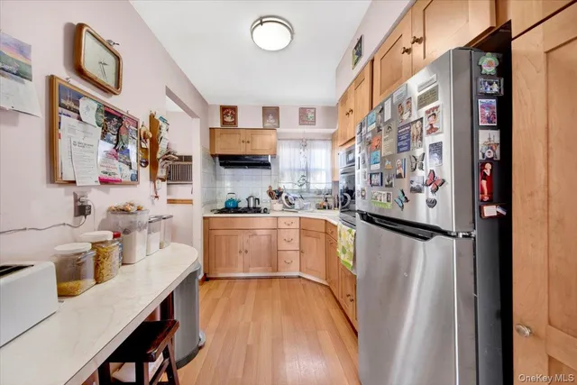 a kitchen with stainless steel appliances a refrigerator and a stove top oven