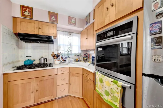 a kitchen with stainless steel appliances a stove a microwave and cabinets