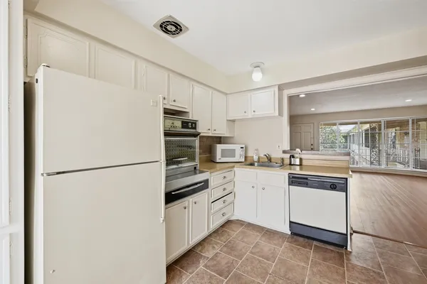 a kitchen with a refrigerator a sink and dishwasher