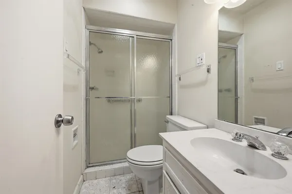 a bathroom with a sink toilet and shower