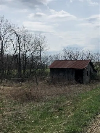 a view of lake with a green space
