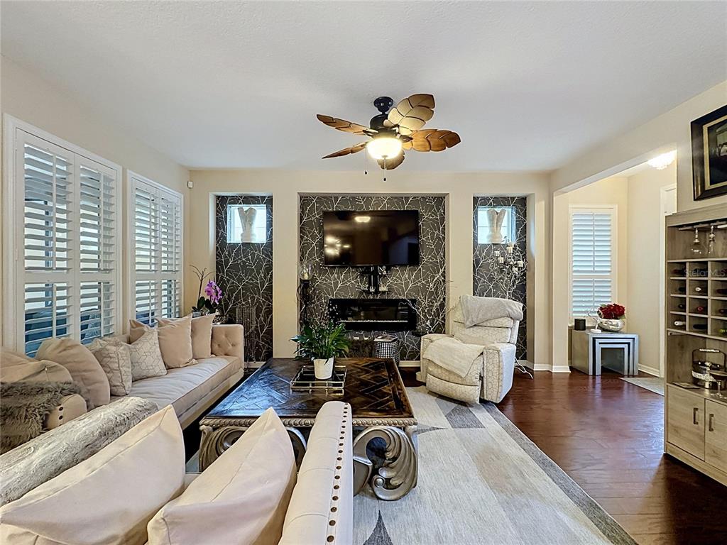 255 Silver Maple Road Groveland, FL 34736 - Photo 10 of 68 a living room with furniture flat screen tv and wooden floor