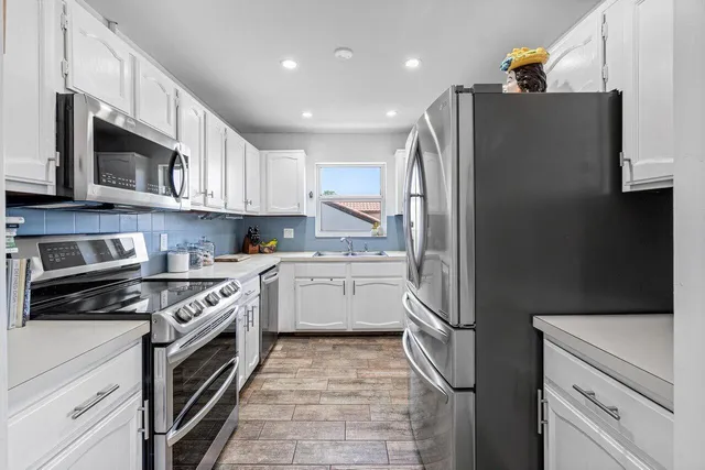 a kitchen with a refrigerator stove and microwave