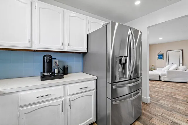 a kitchen with stainless steel appliances a refrigerator and cabinets