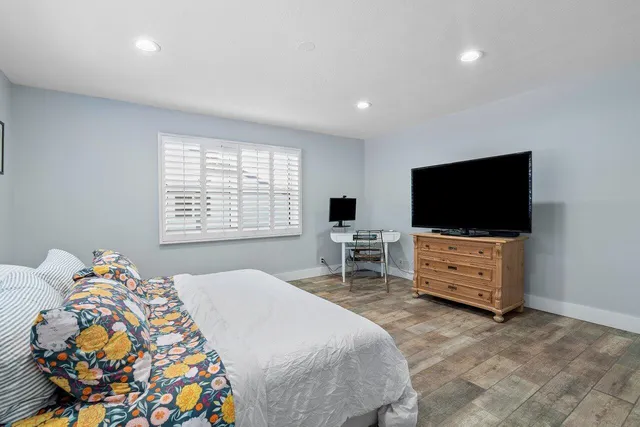 a bedroom with a bed and a flat screen tv