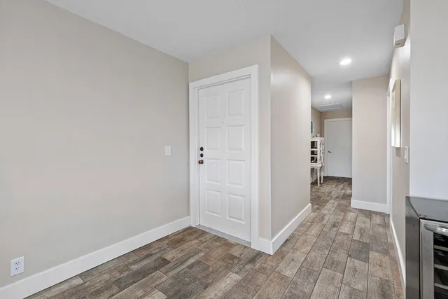 a view of a hallway with wooden floor