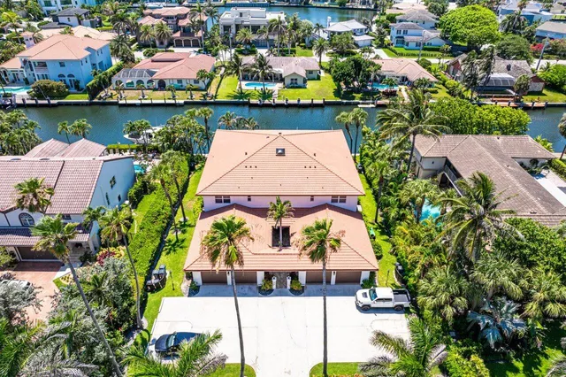 an aerial view of residential houses with outdoor space and lake view