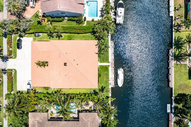 an aerial view of a residential houses with yard