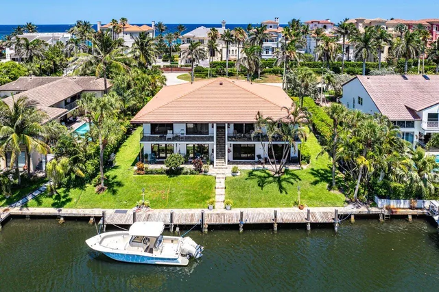 an aerial view of a house with a garden and lake view
