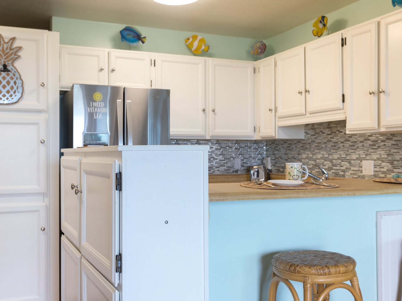 2075 South Kihei Road, Unit 113 Kihei, HI 96753 - Photo 14 of 24 a kitchen with stainless steel appliances a refrigerator and a stove