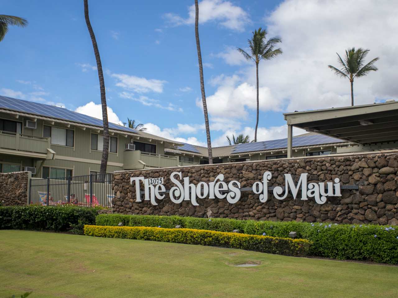 2075 South Kihei Road, Unit 113 Kihei, HI 96753 - Photo 22 of 24 a street sign on the side of building