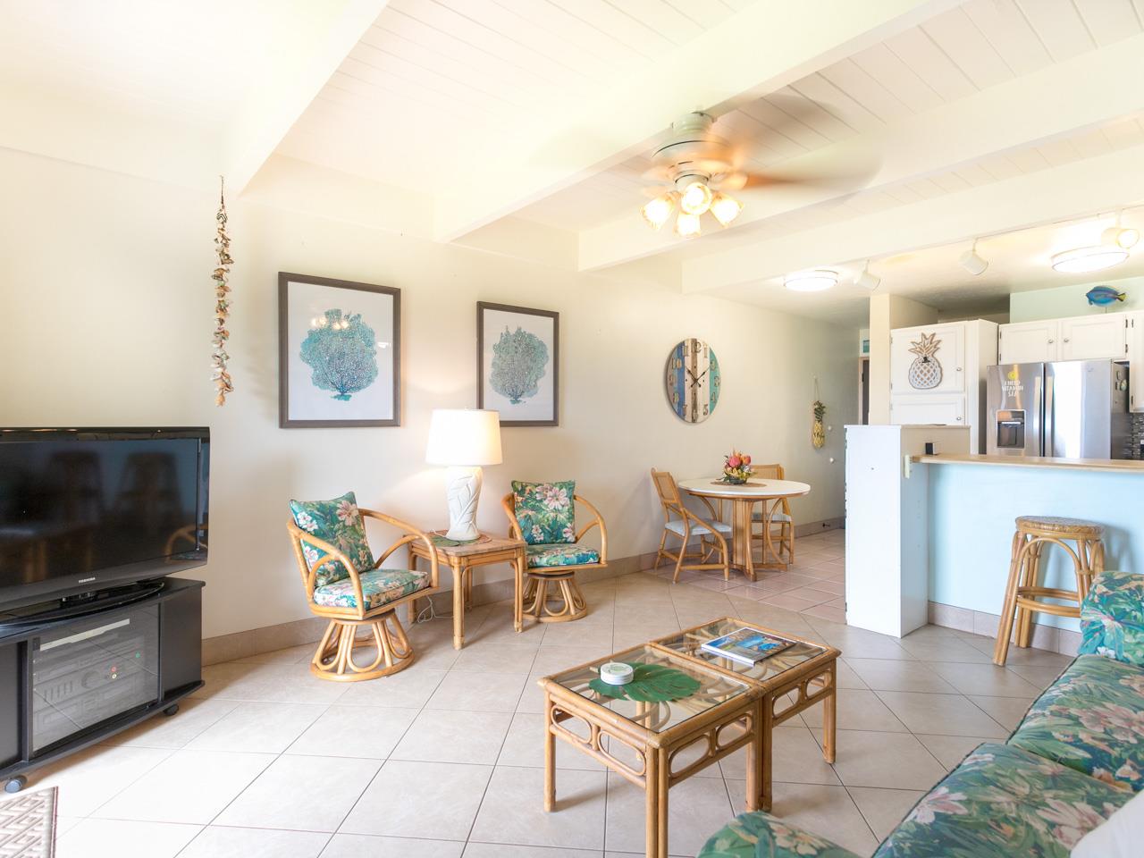 2075 South Kihei Road, Unit 113 Kihei, HI 96753 - Photo 3 of 24 a living room with furniture and a flat screen tv