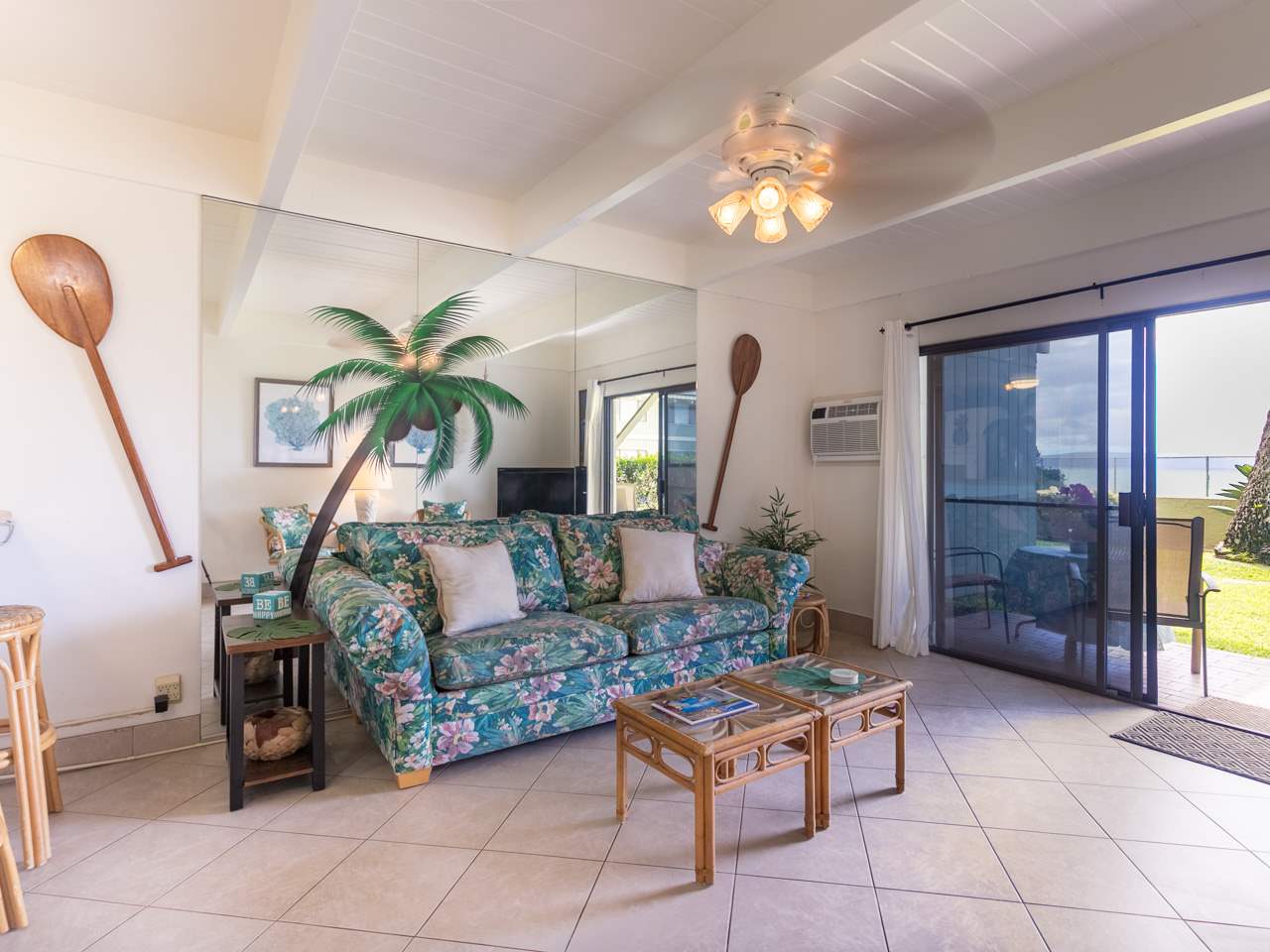 2075 South Kihei Road, Unit 113 Kihei, HI 96753 - Photo 4 of 24 a living room with furniture a chandelier and a dining table