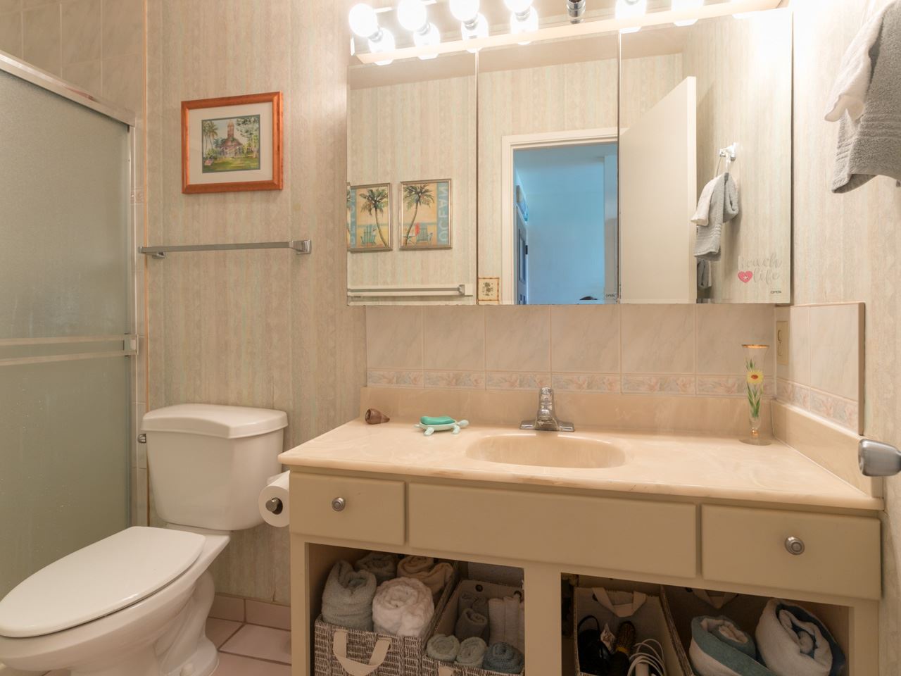 2075 South Kihei Road, Unit 113 Kihei, HI 96753 - Photo 7 of 24 a bathroom with a sink a toilet and mirror
