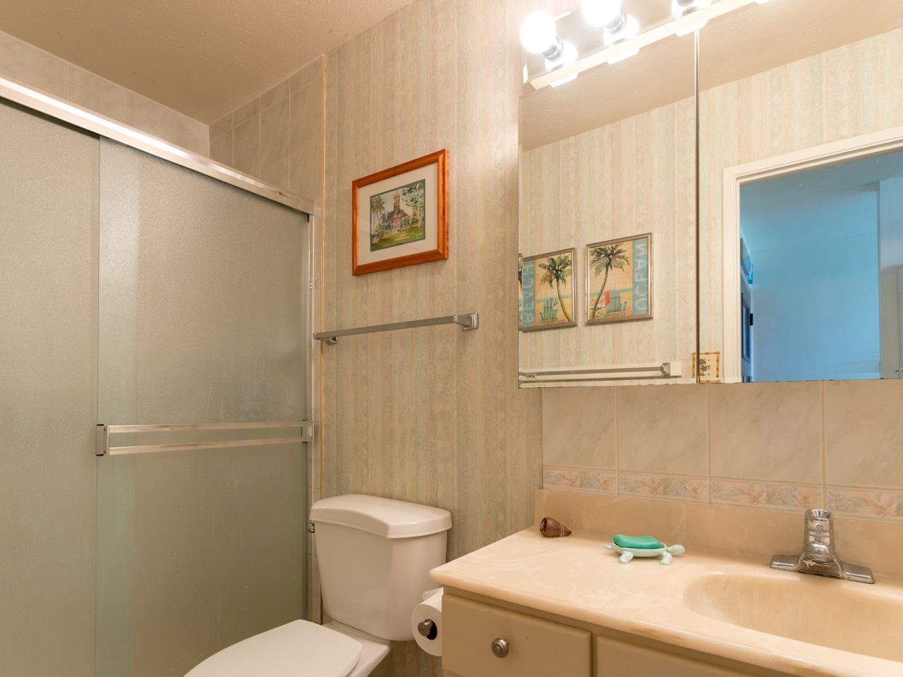 2075 South Kihei Road, Unit 113 Kihei, HI 96753 - Photo 8 of 24 a bathroom with a sink mirror and toilet
