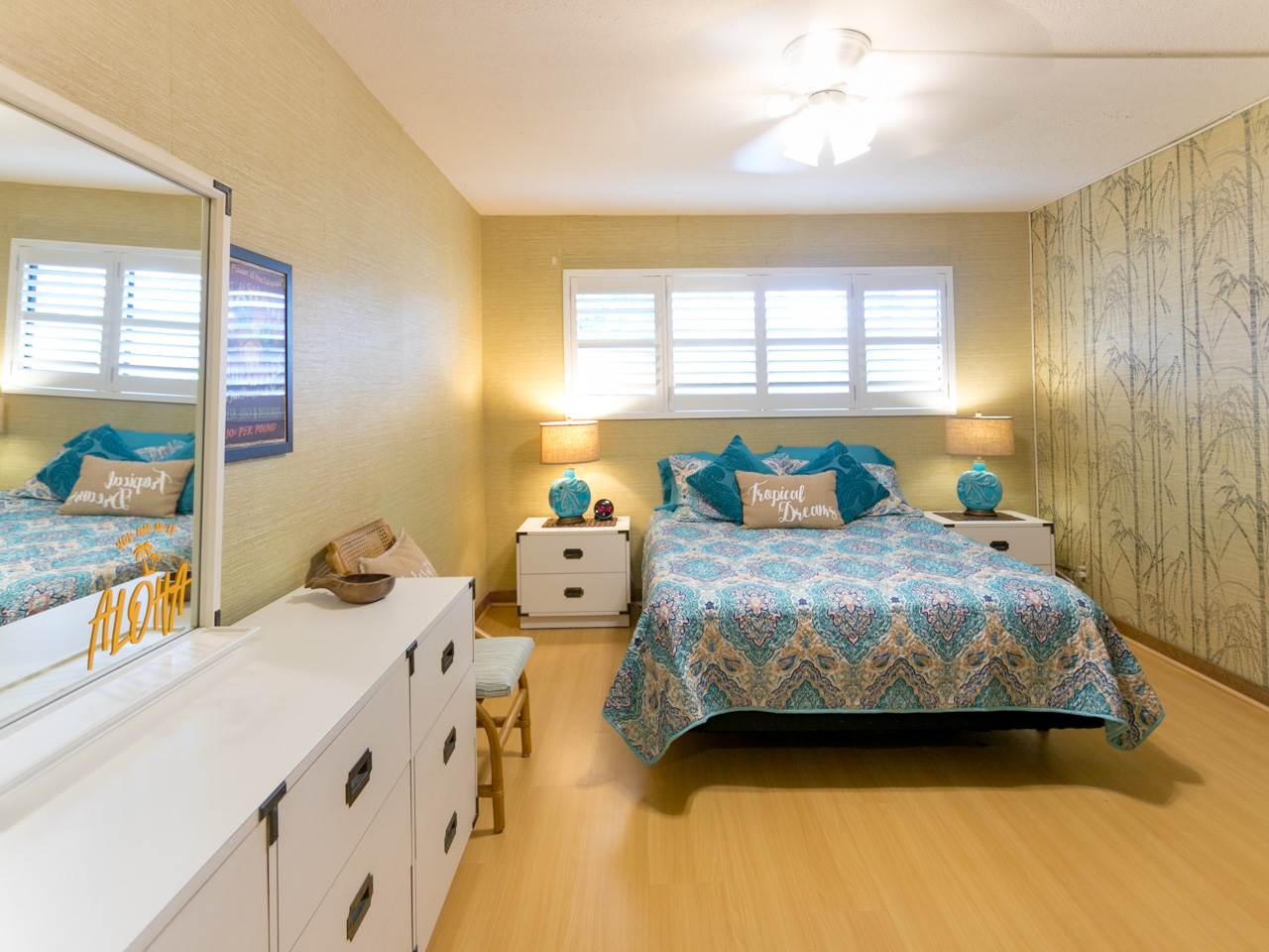 2075 South Kihei Road, Unit 113 Kihei, HI 96753 - Photo 9 of 24 a bedroom with a bed and wooden floor