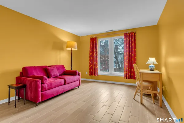 a view of room with furniture and wooden floor