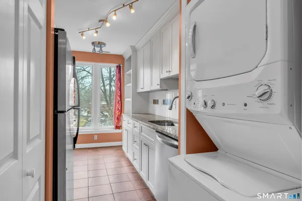 a kitchen with a refrigerator and a stove