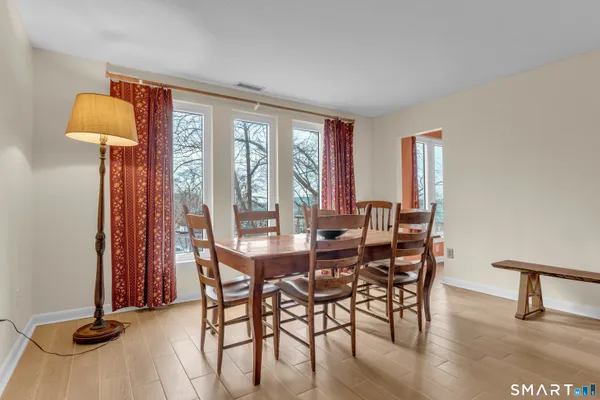 a view of a dining room with furniture and a window