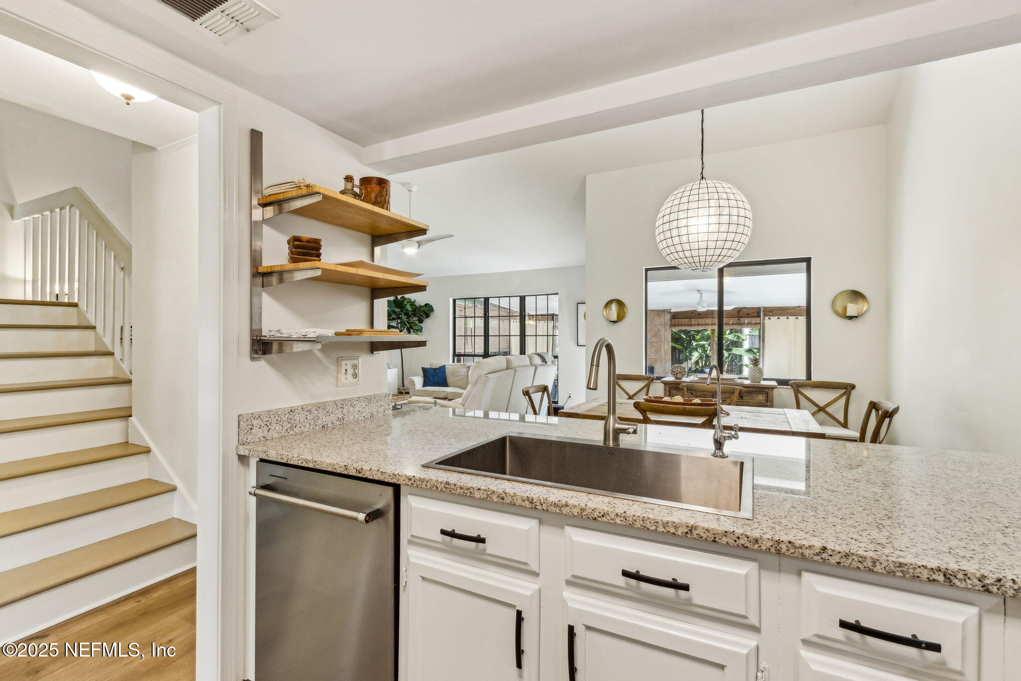 2751 West 5th Street, Unit B Fernandina Beach, FL 32034 - Photo 19 of 61 a kitchen with stainless steel appliances granite countertop a sink and a counter space