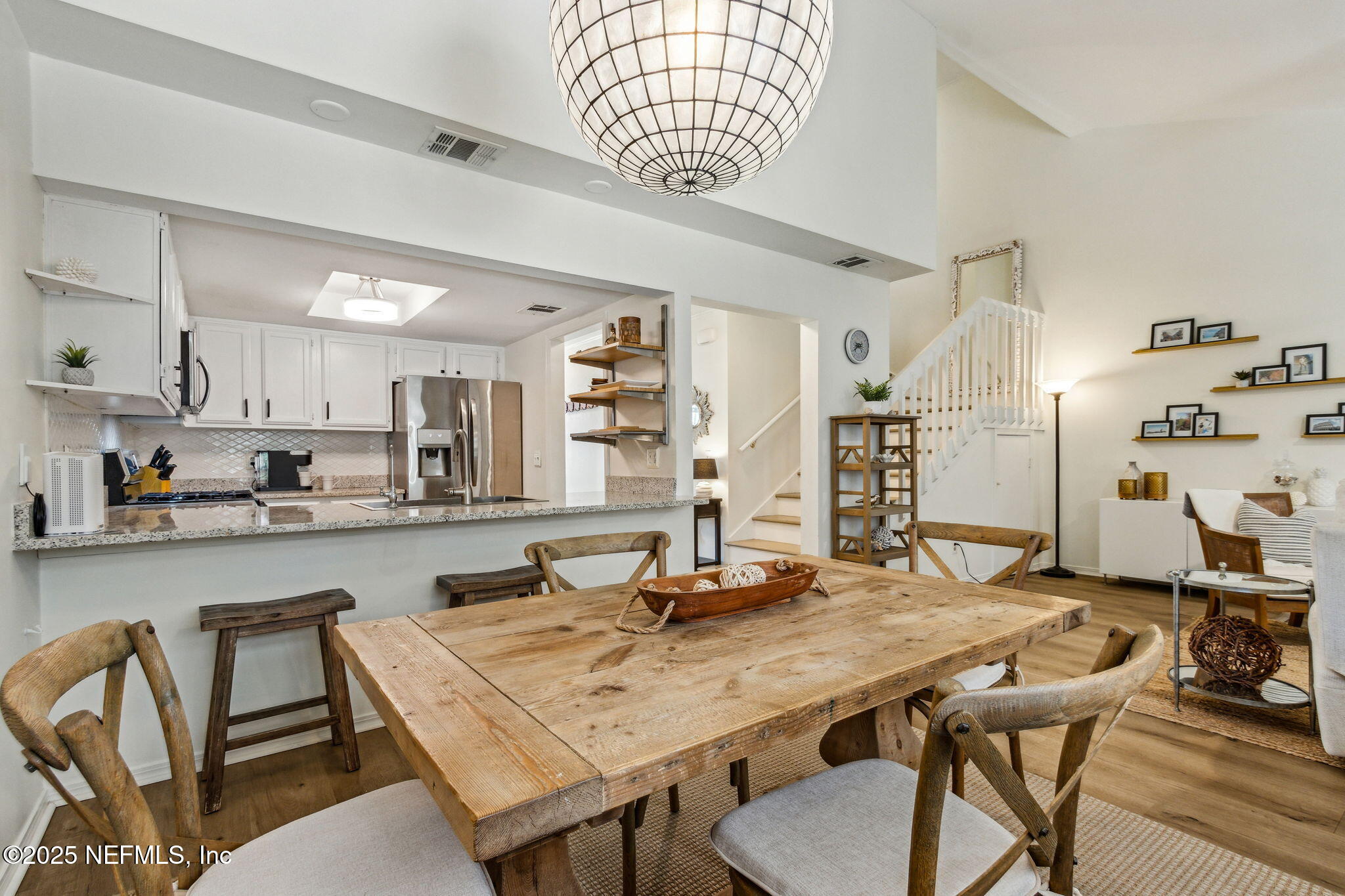 2751 West 5th Street, Unit B Fernandina Beach, FL 32034 - Photo 22 of 61 a room with stainless steel appliances kitchen island granite countertop a dining table and chairs