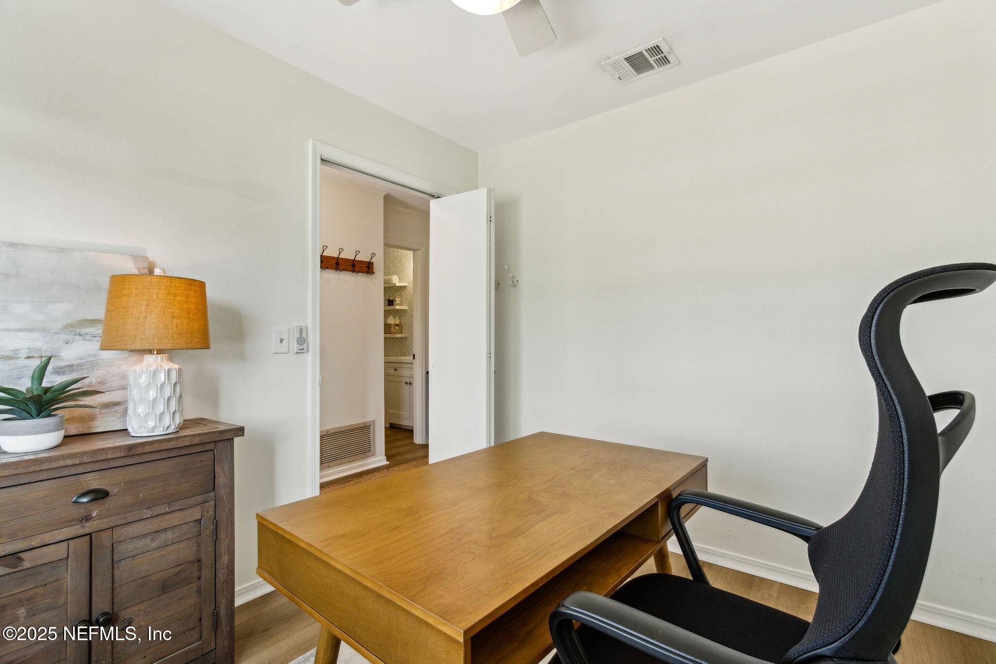 2751 West 5th Street, Unit B Fernandina Beach, FL 32034 - Photo 26 of 61 a room with a table and a potted plant