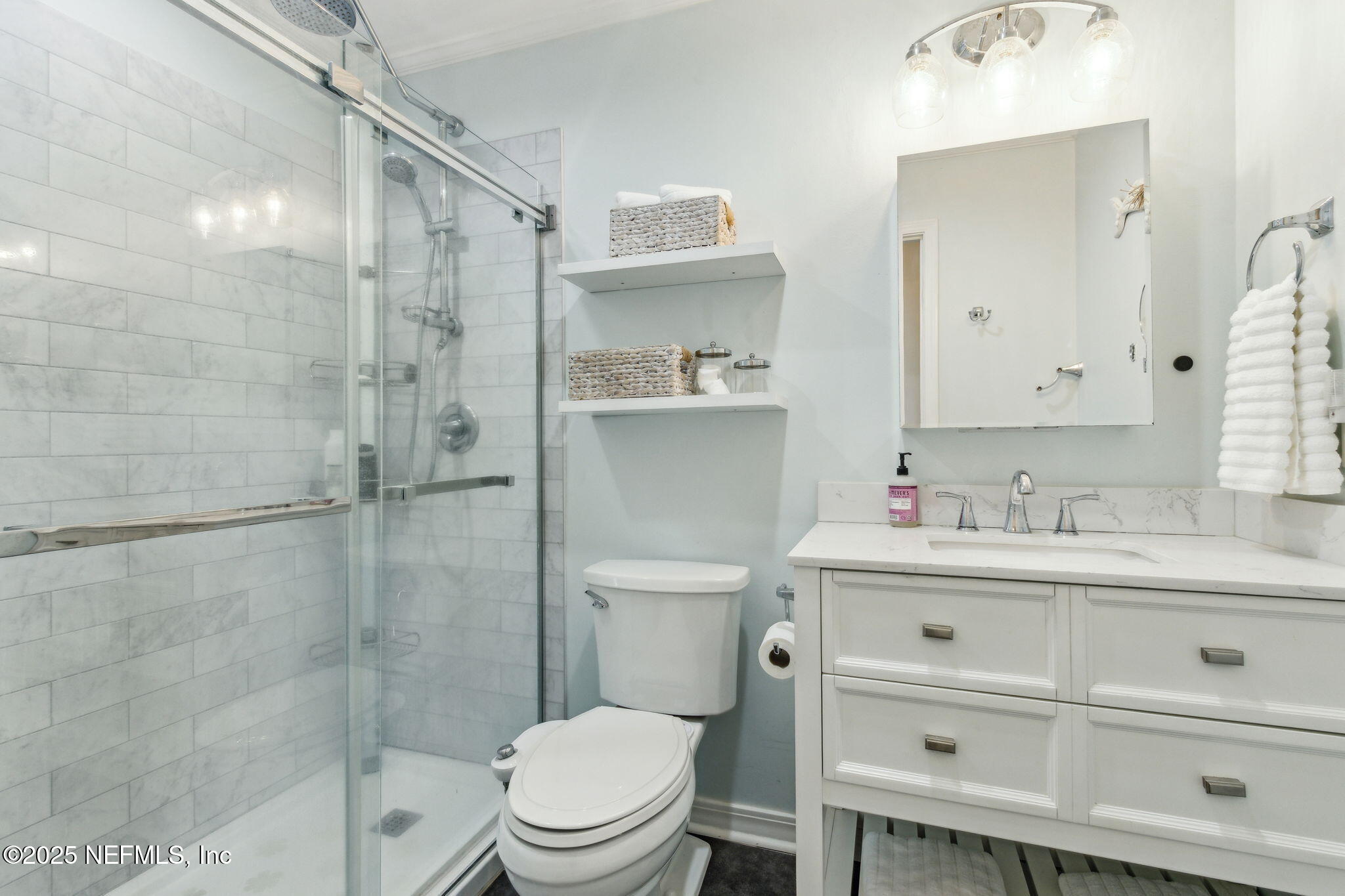 2751 West 5th Street, Unit B Fernandina Beach, FL 32034 - Photo 33 of 61 a bathroom with a sink a toilet and shower