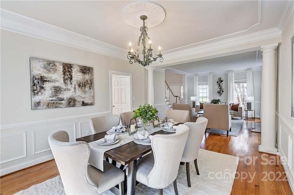 4222 Kronos Place Charlotte, NC 28210 - Photo 11 of 46 a view of a dining room with furniture wooden floor and a chandelier