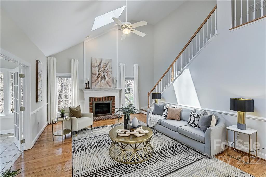 4222 Kronos Place Charlotte, NC 28210 - Photo 20 of 46 a living room with furniture a fireplace and a chandelier