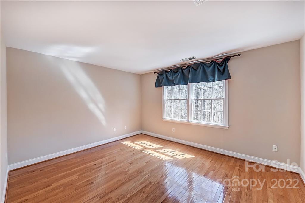 4222 Kronos Place Charlotte, NC 28210 - Photo 35 of 46 a view of an empty room with wooden floor and a window