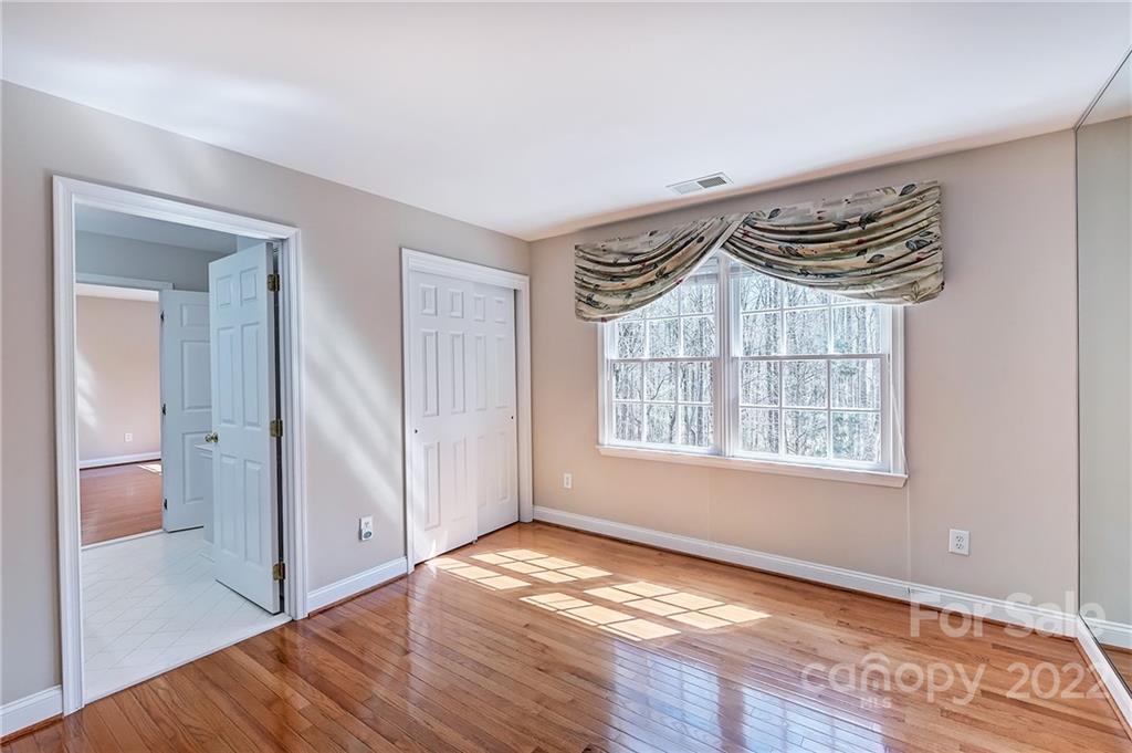 4222 Kronos Place Charlotte, NC 28210 - Photo 37 of 46 a view of an empty room with wooden floor and a window