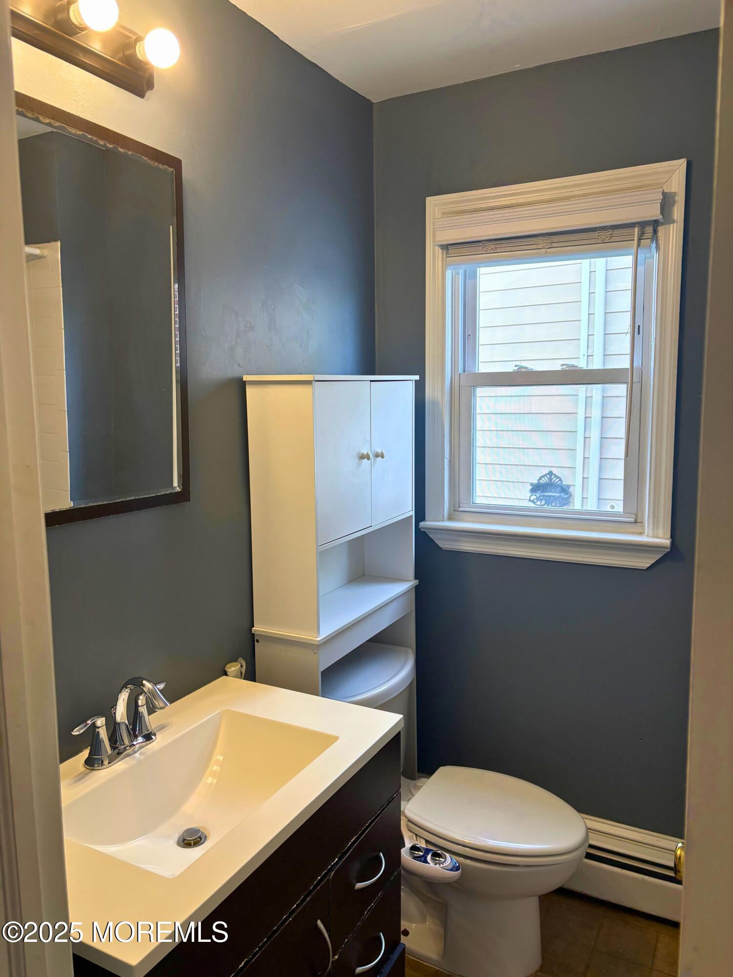 33 Prospect Avenue, Unit C Red Bank, NJ 07701 - Photo 11 of 15 a bathroom with a sink a toilet and mirror