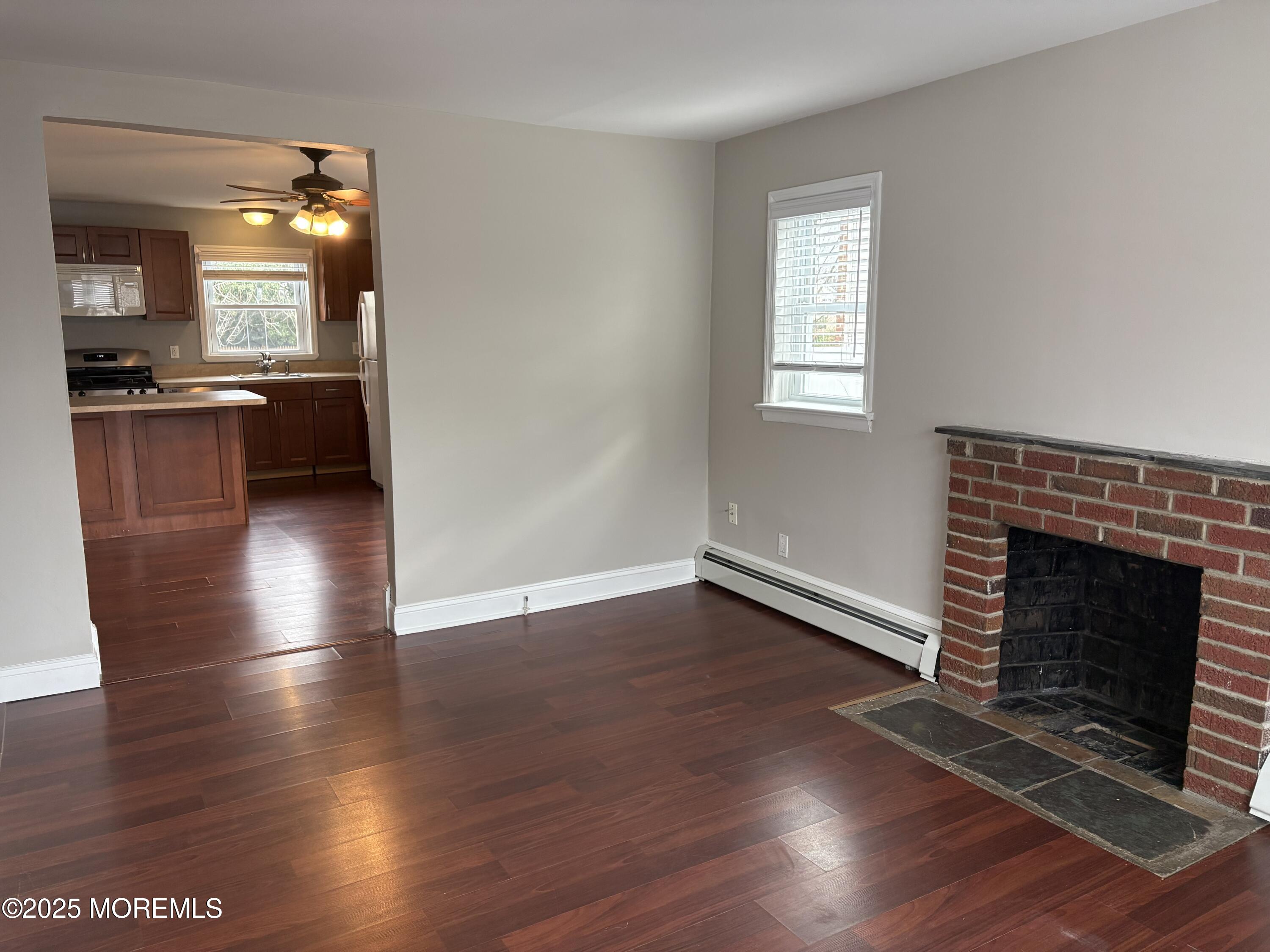 33 Prospect Avenue, Unit C Red Bank, NJ 07701 - Photo 3 of 15 an empty room with wooden floor and a fireplace