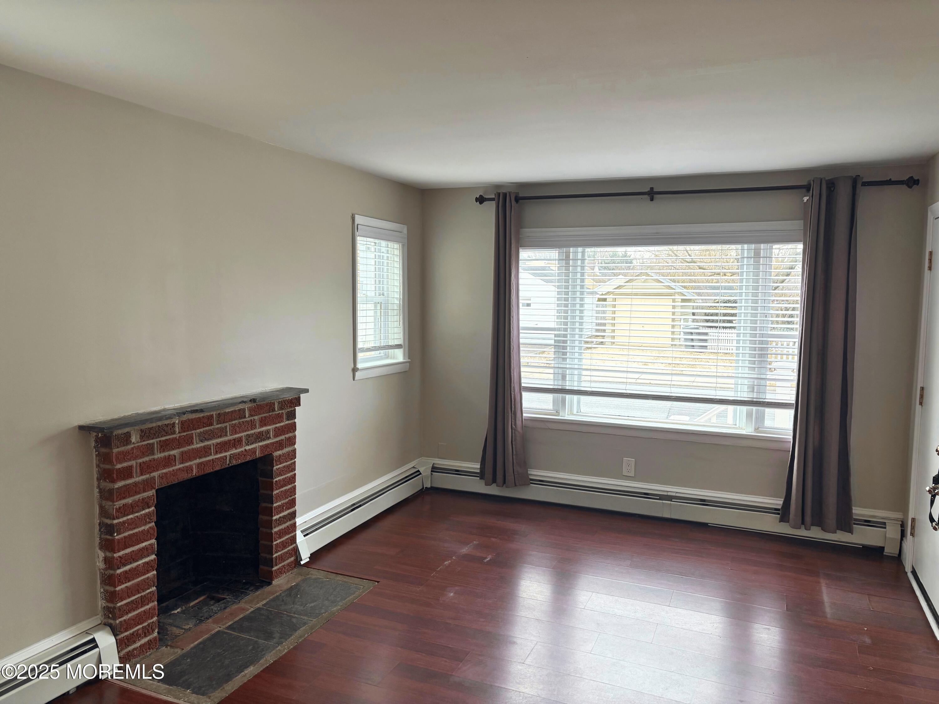 33 Prospect Avenue, Unit C Red Bank, NJ 07701 - Photo 5 of 15 an empty room with wooden floor fireplace and windows