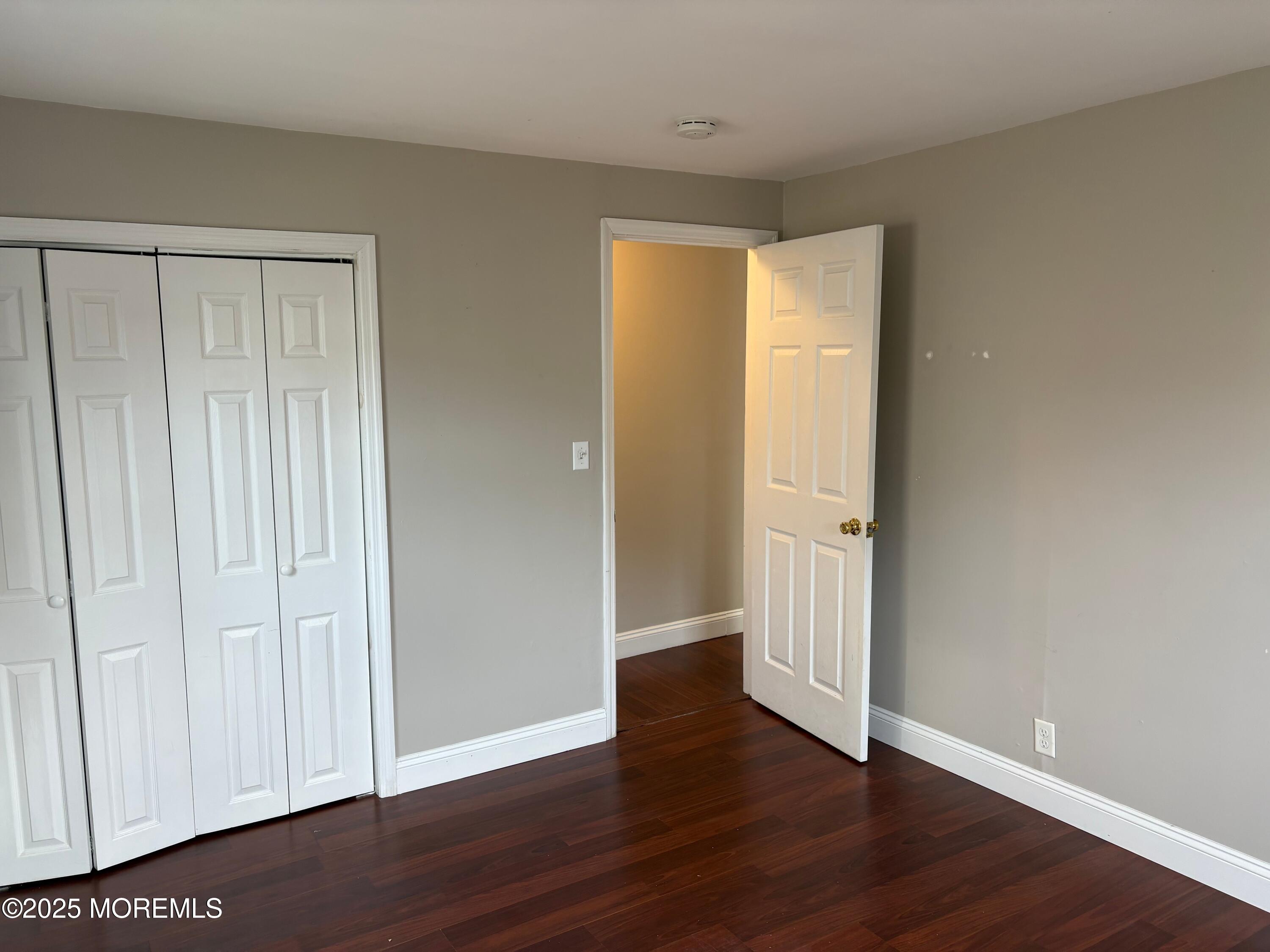 33 Prospect Avenue, Unit C Red Bank, NJ 07701 - Photo 7 of 15 a view of an empty room with wooden floor
