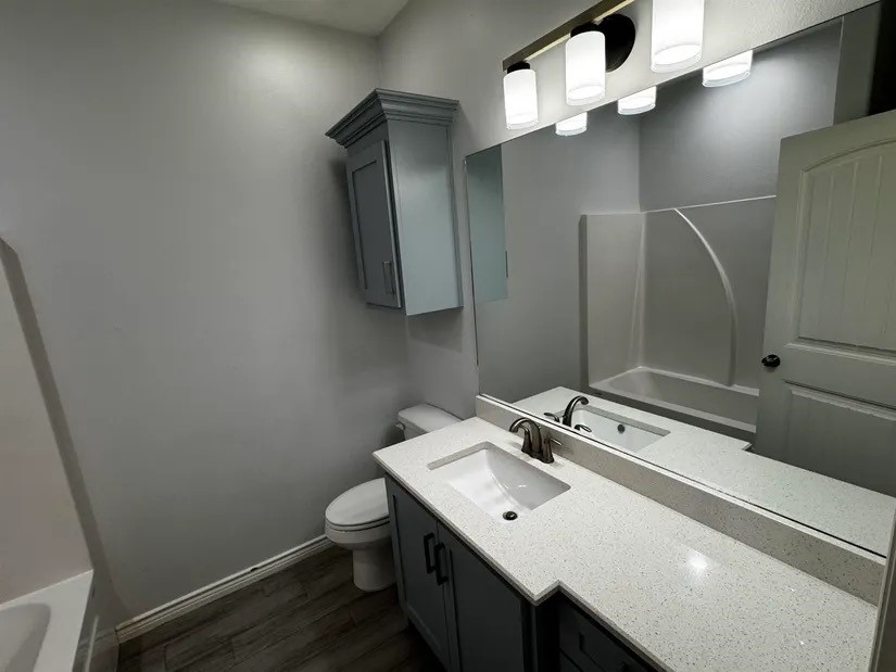 2295 Diamond D Lane Beaumont, TX 77713 - Photo 21 of 40 a bathroom with a sink vanity and toilet