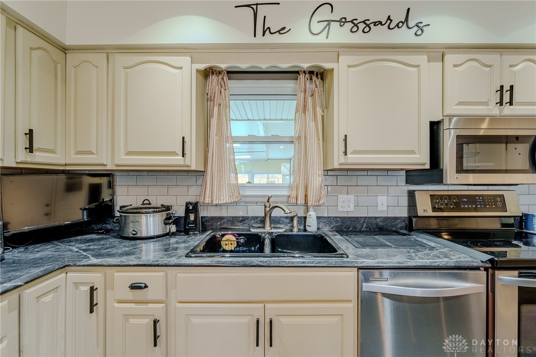 305 South Vandemark Road Sidney, OH 45365 - Photo 20 of 32 This charming kitchen offers abundant cabinet storage, sleek appliances, and a window for natural light.