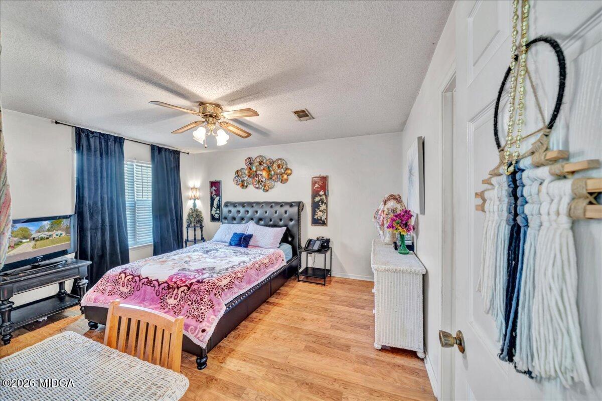 122 Wesleyan Way Macon, GA 31210 - Photo 11 of 20 a bedroom with a bed table and a flat screen tv