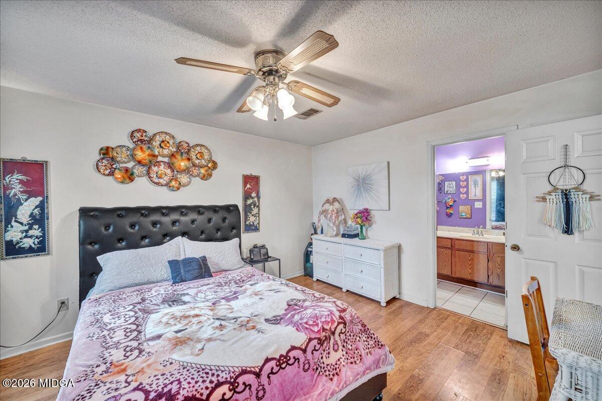 122 Wesleyan Way Macon, GA 31210 - Photo 13 of 20 a bedroom with a bed and a chandelier