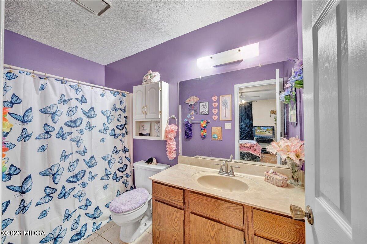 122 Wesleyan Way Macon, GA 31210 - Photo 14 of 20 a bathroom with a sink toilet vanity and shower