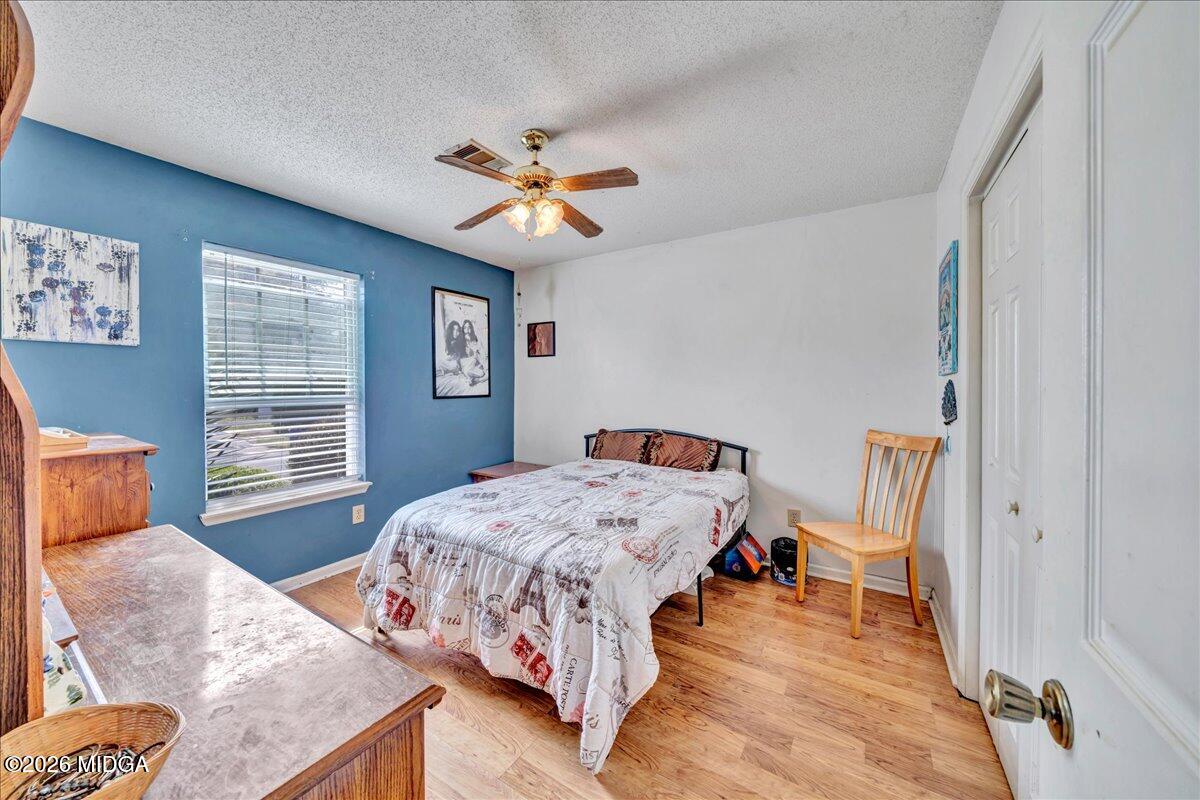 122 Wesleyan Way Macon, GA 31210 - Photo 15 of 20 a bedroom with a bed and wooden floor